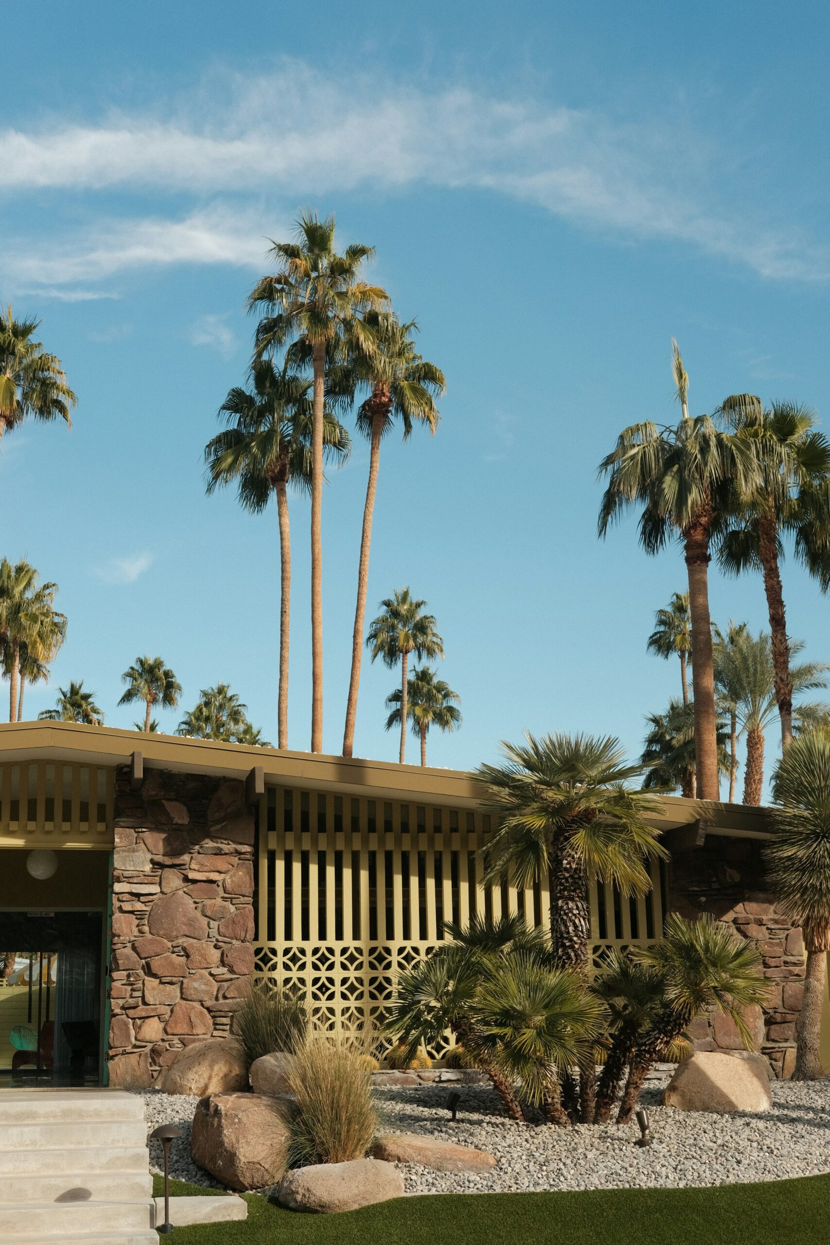 1960s mid-century modern home exterior in Northridge, CA with stone accents and palm trees